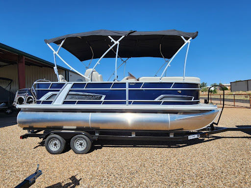 New pontoon boat on trailer under sunny sky