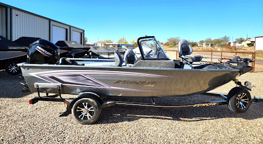 Silver Starcraft fishing boat on trailer outdoors